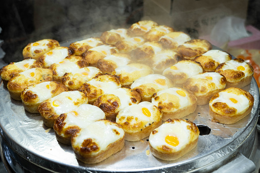 Korean egg bread, Gyeran-ppang, being displayed on a hot steamer. Korean style egg bread in Myeongdong, South Korea.
