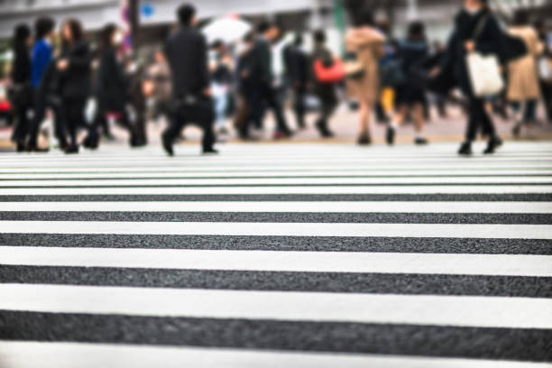 istock defocused people crossing the street 1203693502