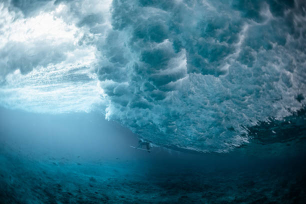 underwater view of the surfer passing the ocean wave - coral break imagens e fotografias de stock