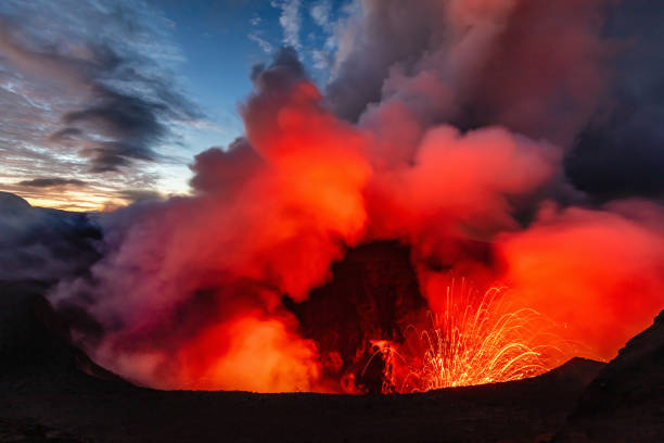 Mount Yasur Tanna Island Vanuatu Volcano Eruption Eruption of the Volcano Mount Yasur, view from the crater rim down towards the erupting volcano crater of the active Mount Yasur Volcano at Night - Twilight. Tanna Island, Vanuatu, Melanesia, South Pacific Ring Of Fire stock pictures, royalty-free photos & images