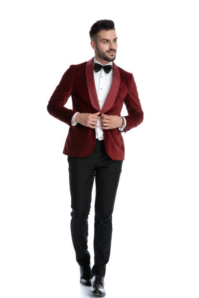 istock happy fashion man adjusting coat and smiling 1203696167