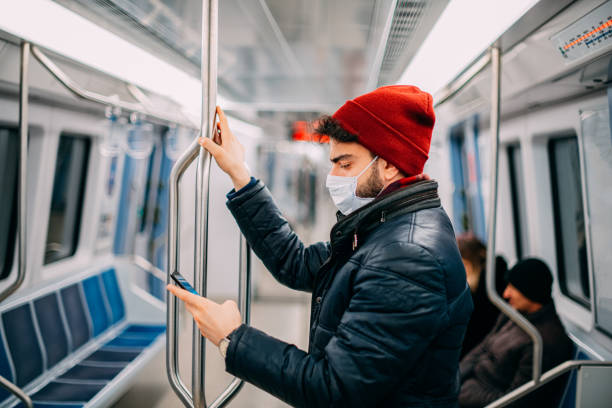 istock Man Wearing a Sterile Mask in the Subway 1203696395