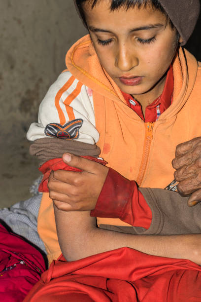 istock a doctor is injecting medicine by a injection into a young sick boy 1203696399