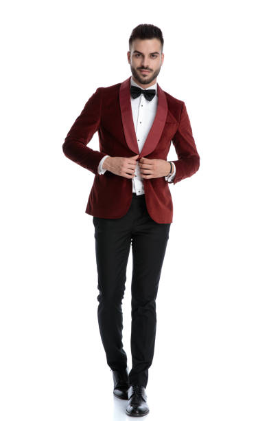 istock smiling young man walking and adjusting coat 1203696450