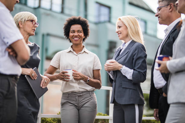 istock Happy business colleagues talking on a coffee break at a terrace. 1203697315