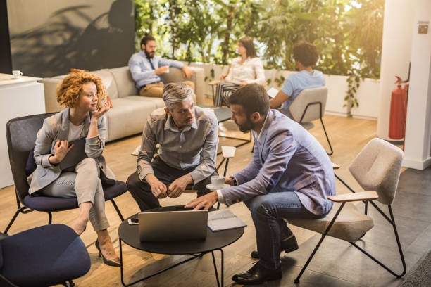 istock Business colleagues talking while using laptop on a casual meeting. 1203698777