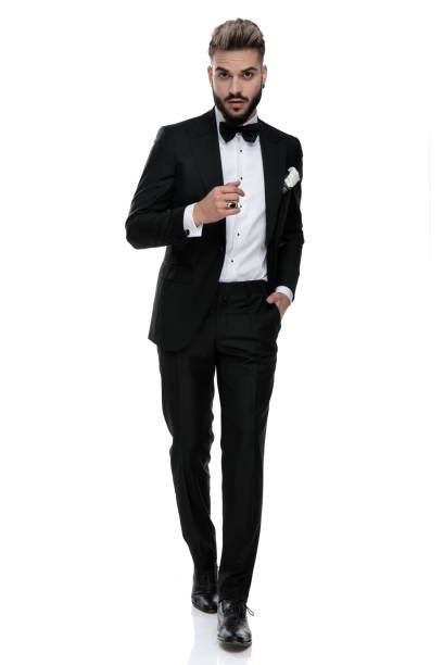 istock businessman walking with hand in pocket and a cool attitude 1203700156