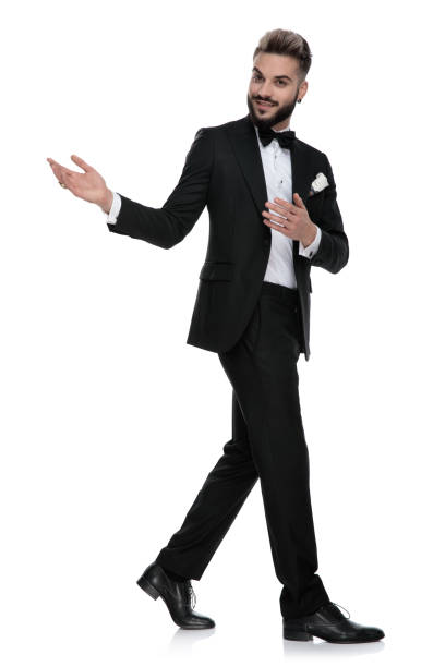 istock businessman walking to a side and presenting to the other 1203700224