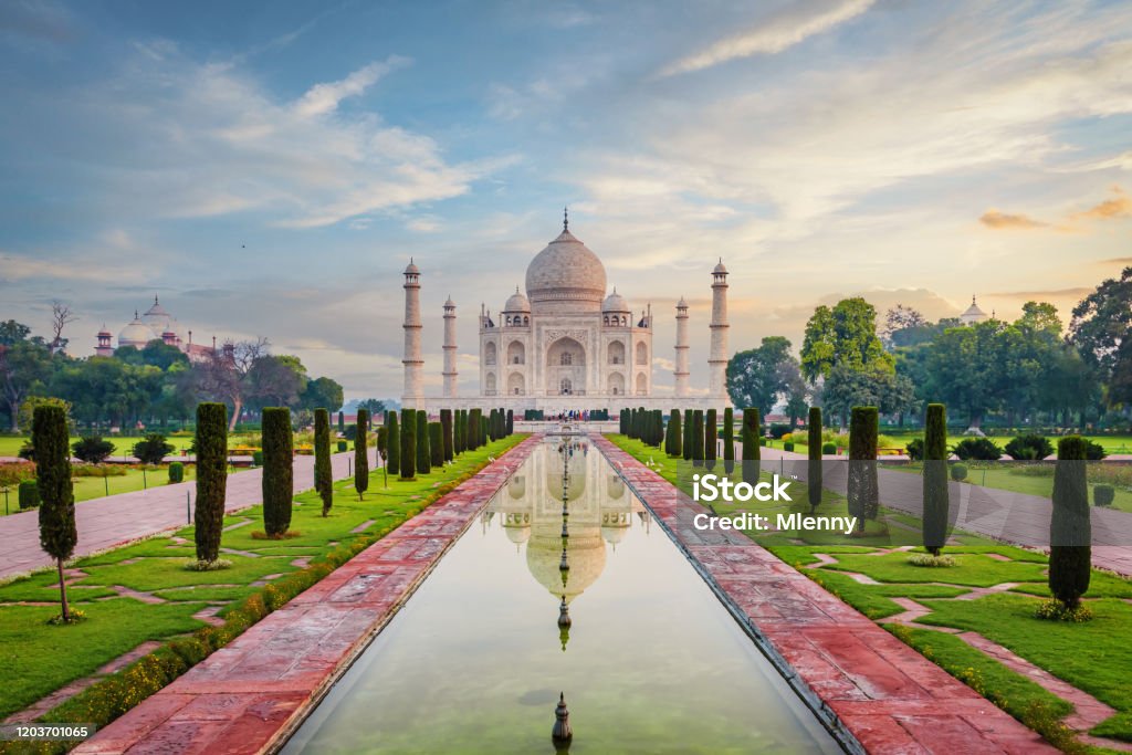 Taj Mahal Agra Moody Sunrise Twilight Relections India The famous Taj Mahal Mausoleum with reflection in the pond under moody sunrise twilight skyscape. The Taj Mahal is one of the most recognizable structures worldwide and regarded as one of the eight wonders of the world. Agra, India, Asia. Taj Mahal Stock Photo