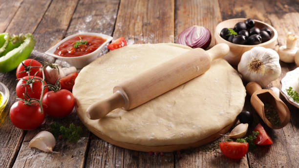 istock assorted of pizza dough and ingredient 1203701372