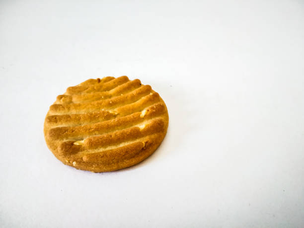 istock a brownish Cashew cookie with white background. 1203701399