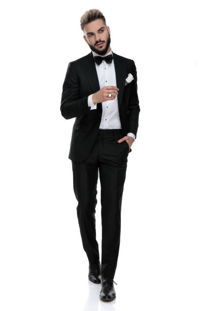 istock businessman walking with hand in pocket looking away seductive 1203701600