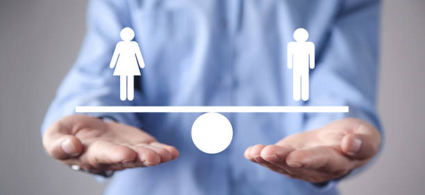 istock Man showing balance scale. Man and Woman equality 1203702279