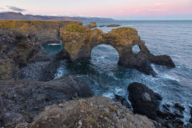 istock Gatklettur, Arch Rock a cliff with a circular arch, Arnarstapi, Iceland 1203703580