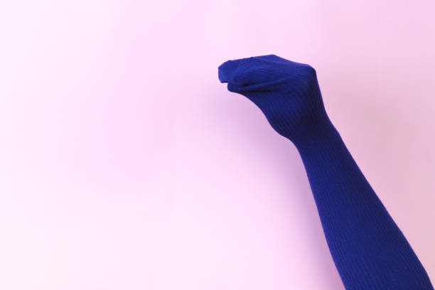 istock funny doll sock on pink background, hand theater 1203703995