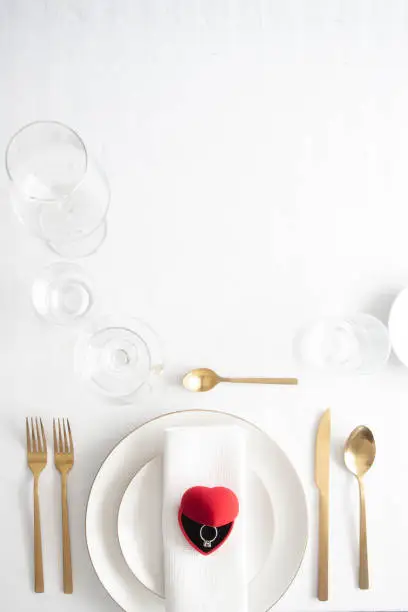 Elegant Table setting  with ed box with engagement ring.Saint valentines day celebration or propose romantic dinner concept.Copy space