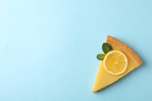 istock Lemon tart slice on blue background, space for text 1203707297