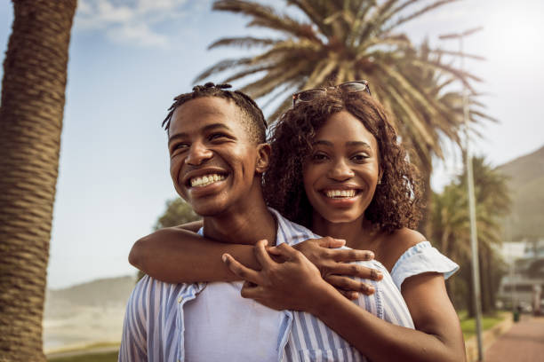 istock Young Romantic Couple Piggybacking On The Beach 1203708076