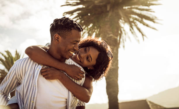 istock Young Romantic Couple Piggybacking On The Beach 1203708120