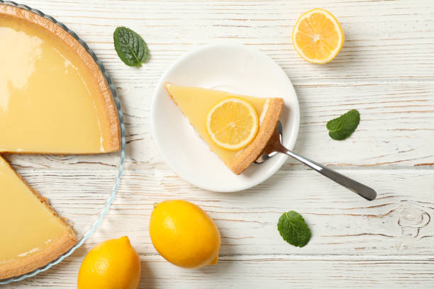 istock Composition with lemon tart on white wooden background, top view 1203708691