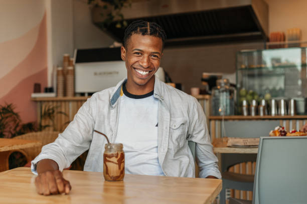 istock Young African Man In Cafe 1203708720
