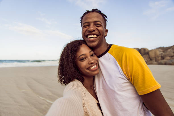 istock Couple Enjoy Beautiful Sunny Day On The Beach 1203708743
