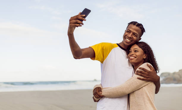istock African Couple Making Selfie On The Beach 1203708745