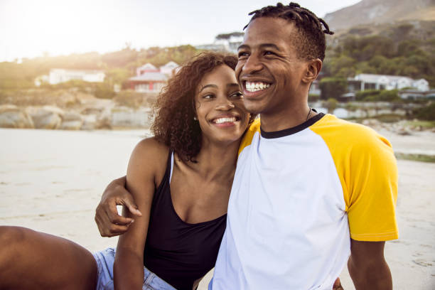 istock African Couple Enjoy Sunny Day On The Beach 1203708759
