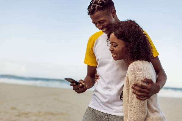 istock African Couple Enjoy Sunny Day On The Beach 1203708770