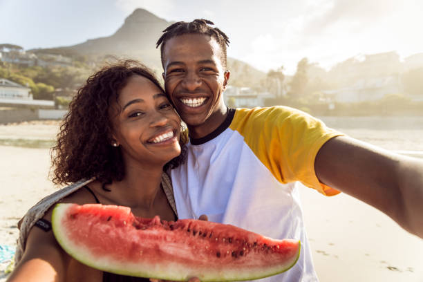 istock African Couple Enjoy Sunny Day On The Beach 1203708842