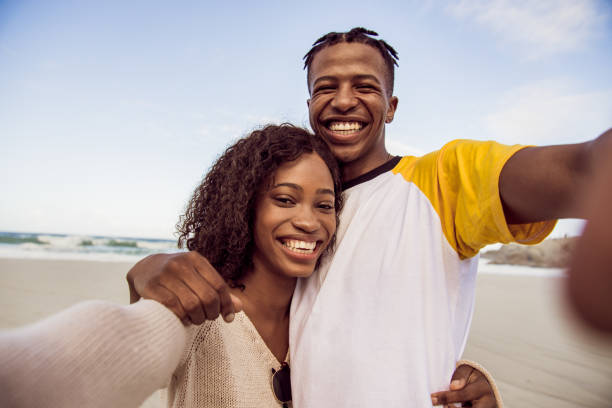 istock African Couple Enjoy Sunny Day On The Beach 1203708846