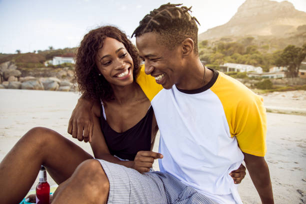 istock African Couple Enjoy Sunny Day On The Beach 1203708852