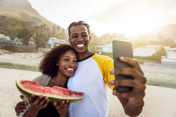 istock African Couple Enjoy Sunny Day On The Beach 1203708887