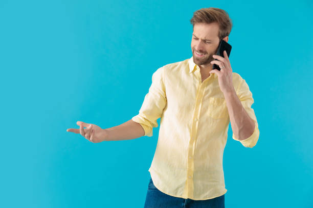 istock Bothered casual man disagreeing on his phone and gesturing 1203709095