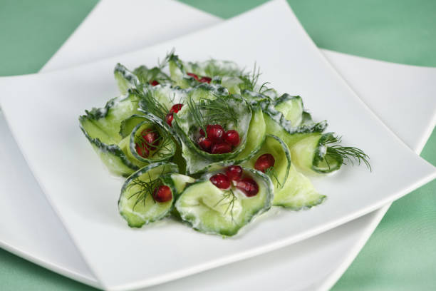 istock Fresh cucumber salad with dill and pomegranate kernels, in yoghurt sauce 1203709135