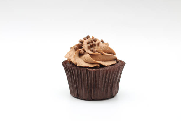 istock Isolated chocolate cupcake with cream top and crispy topping on a white background 1203709285