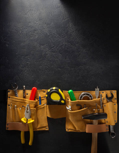 istock tools and instruments in belt on wooden background 1203709337