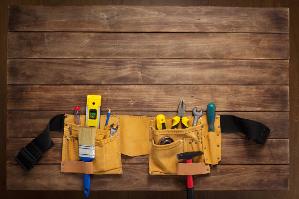 istock tools and instruments in belt on wooden background 1203709579