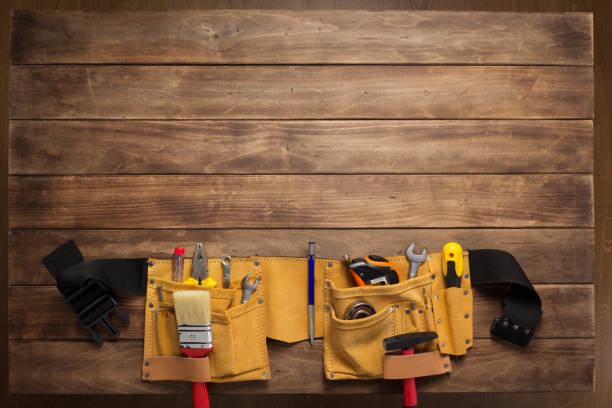 istock tools and instruments in belt on wooden background 1203709605