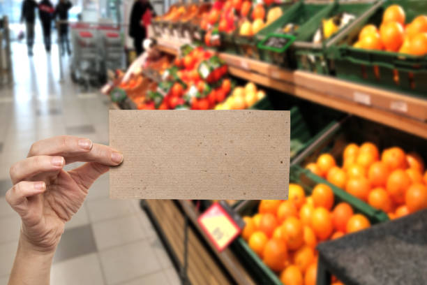 message blank card in woman hand in store with fruit and vegetables