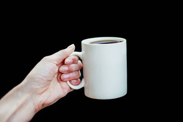 istock A person holds in his hand a white cup 1203710269