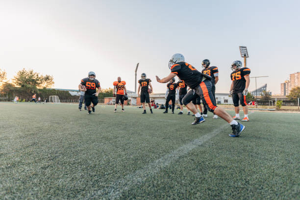 istock Football players playing a match on a field 1203710287
