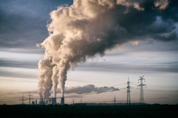 pollution spilling into the sky from a cola fired power plant - lignite imagens e fotografias de stock
