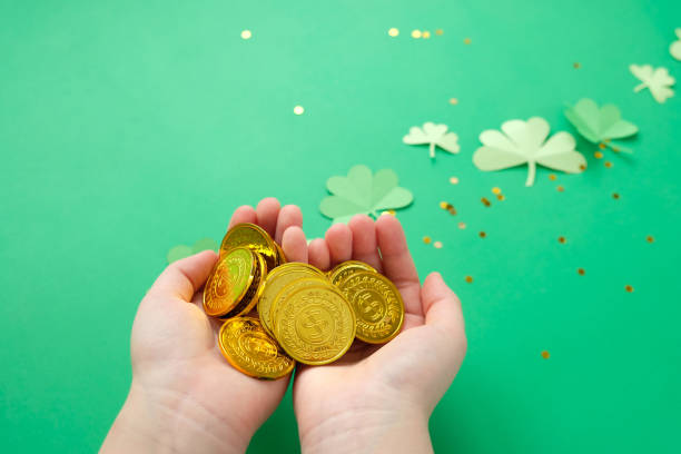 istock St. Patrick's day, clover and gold coins on a green background 1203713487