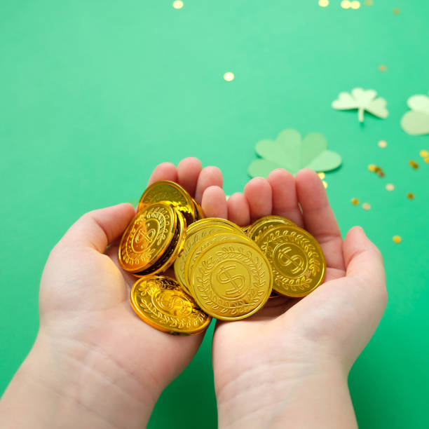 istock St. Patrick's day, clover and gold coins on a green background 1203713491