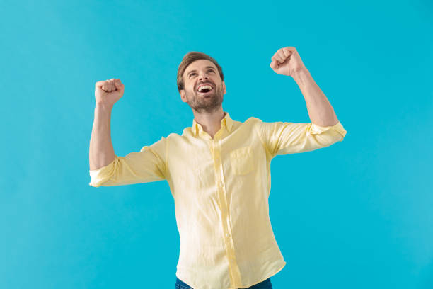 istock Happy casual man celebrating with both fists clenched 1203713520