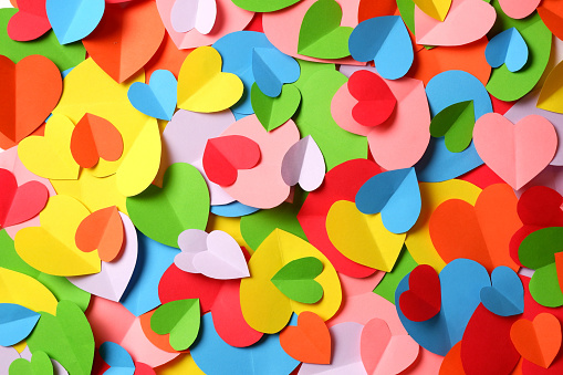 Bunch of multicolored paper hearts cutouts background.  LGBT love, valentines day, equality, freedom, liberty, diversity, variety, tolerance concept.