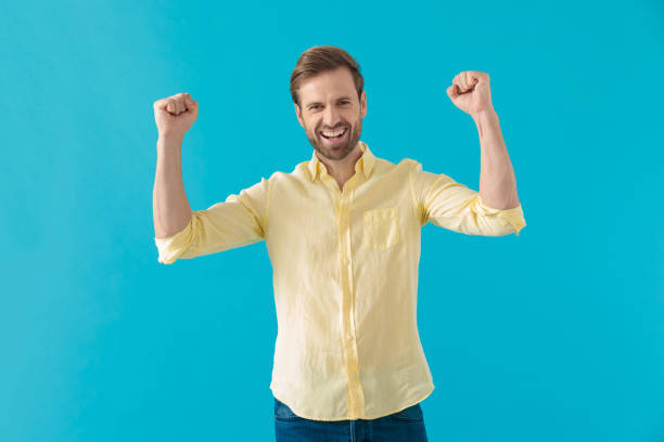 istock Cheerful casual man celebrating and shouting 1203714231