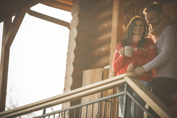 istock Cheerful couple having a romantic weekend getaway in a rustic cabin 1203714379