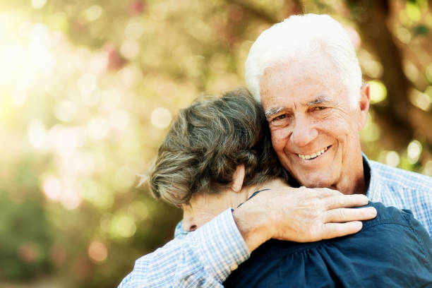 istock Smiling senior man embracing woman 1203714469